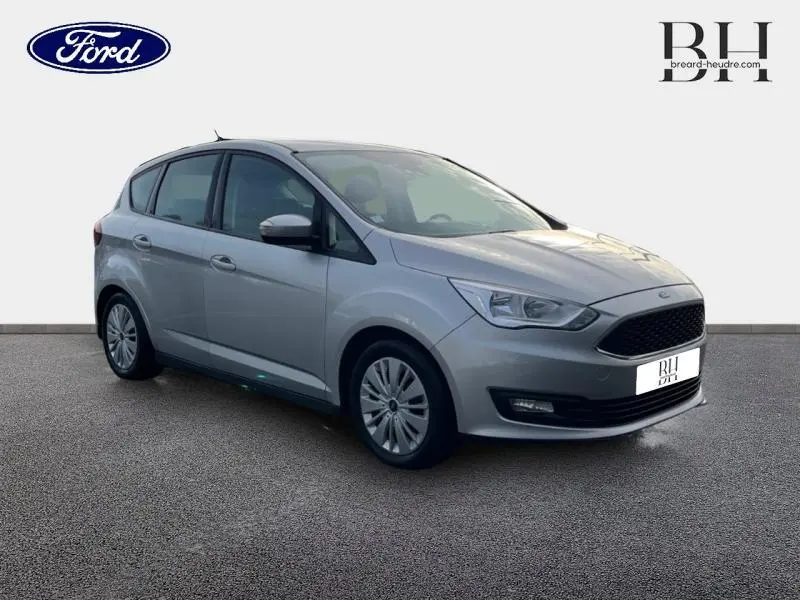 Ford C-MAX gris lunaire vue 3/4 avant droit, avec calandre noire et jantes à enjoliveurs.