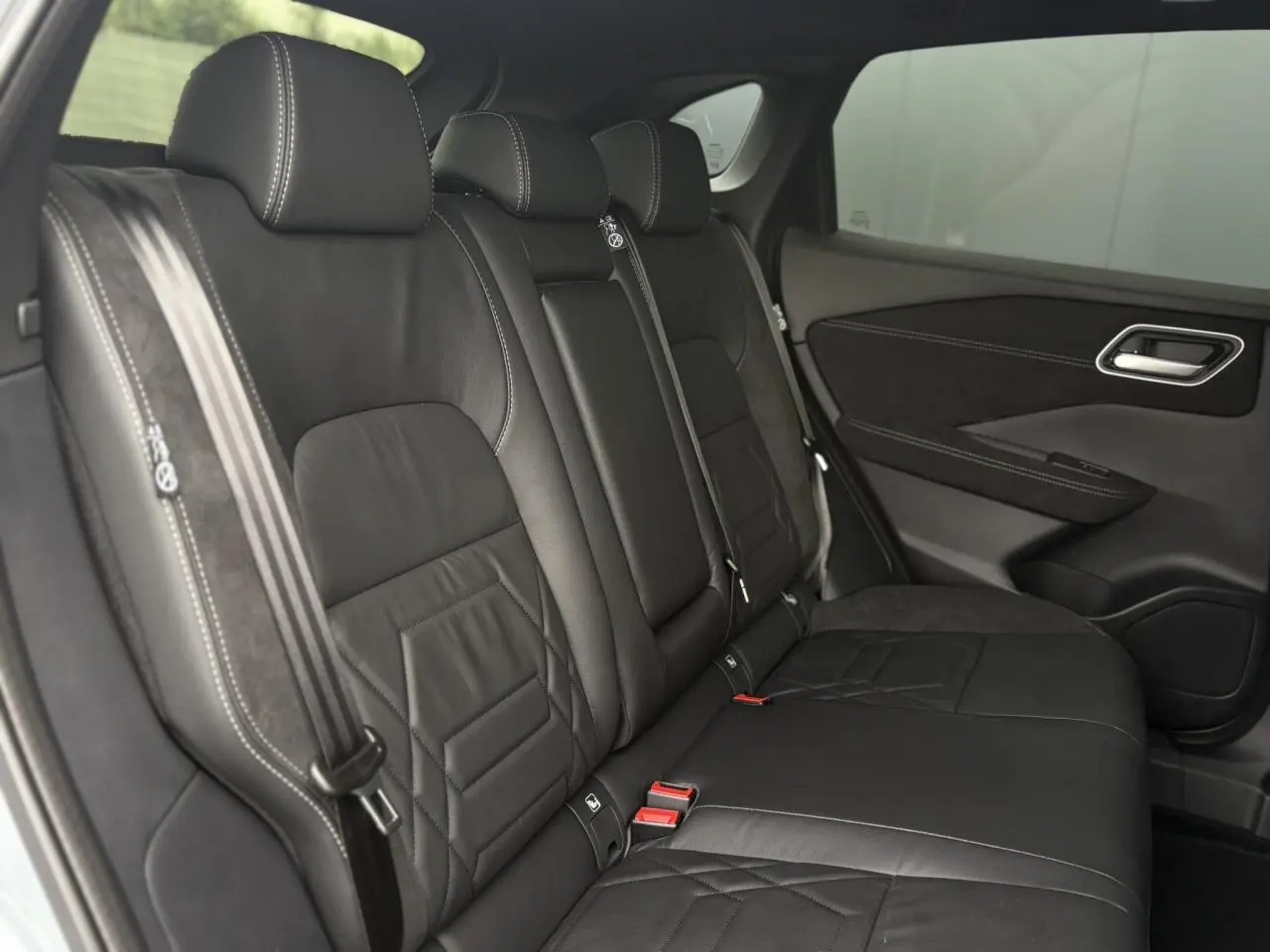 Vue latérale des sièges arrière en cuir noir avec surpiqûres blanches du Nissan Qashqai 2025 N-Design.