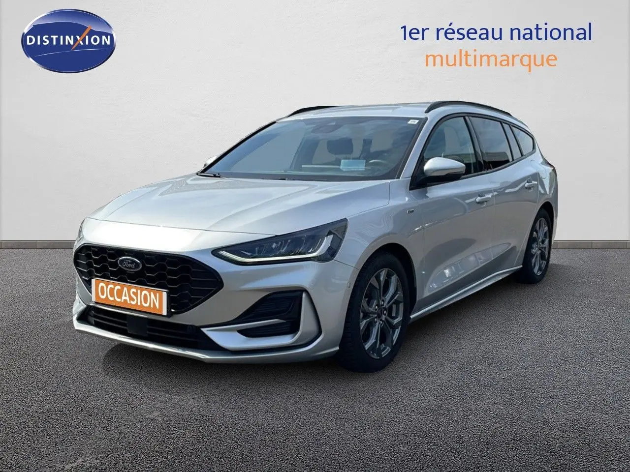Ford Focus SW gris lunaire métal vue 3/4 avant droit, avec calandre noire et jantes alliage.