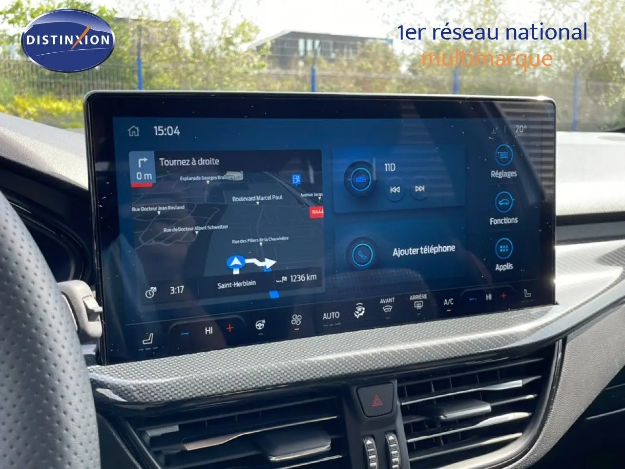 Écran tactile central de la Ford Focus SW gris lunaire, affichant navigation et commandes climatisation, vue intérieure avant.
