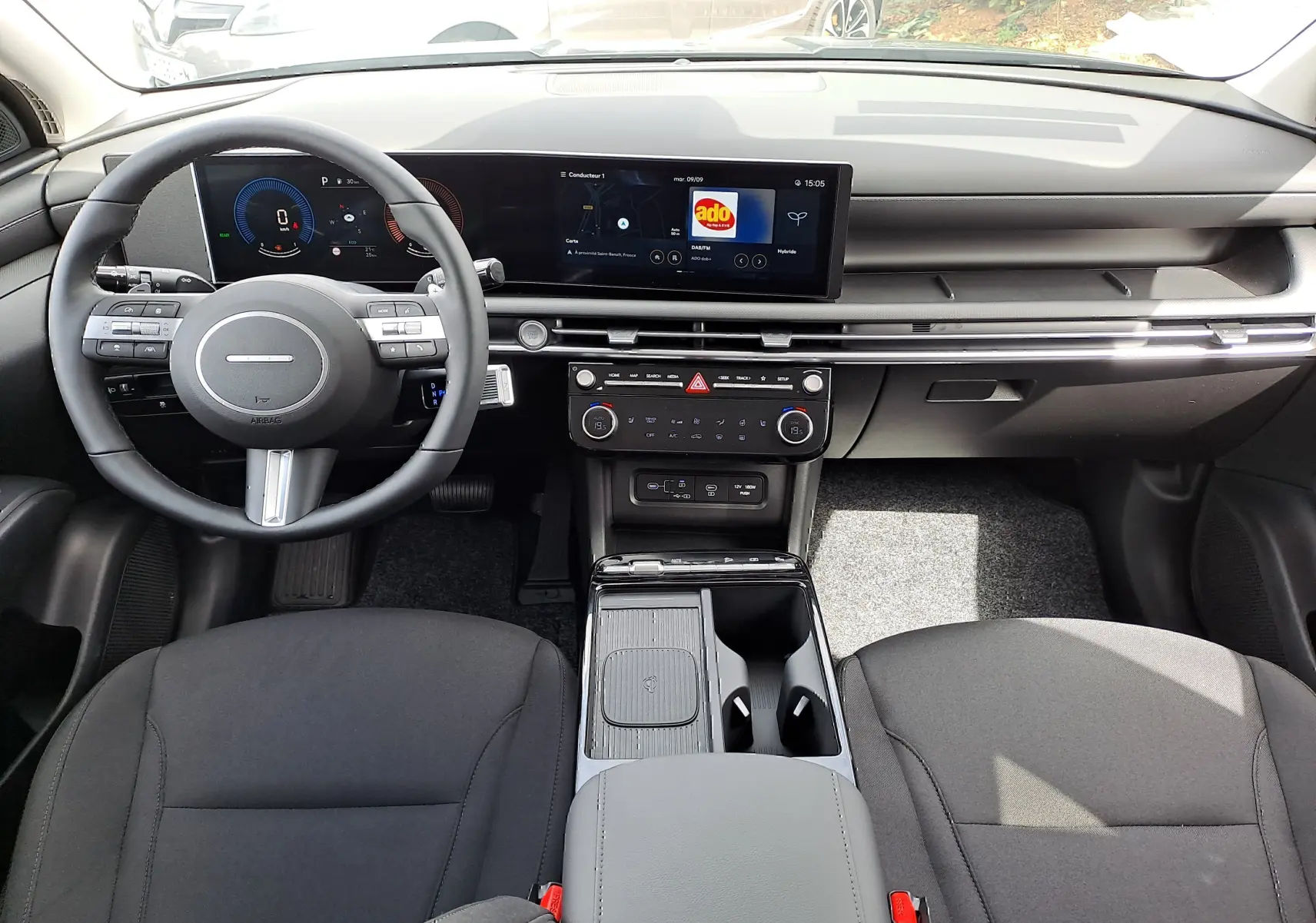 Intérieur noir du Hyundai Tucson 2025, vue frontale du tableau de bord avec écran tactile et volant multifonction.