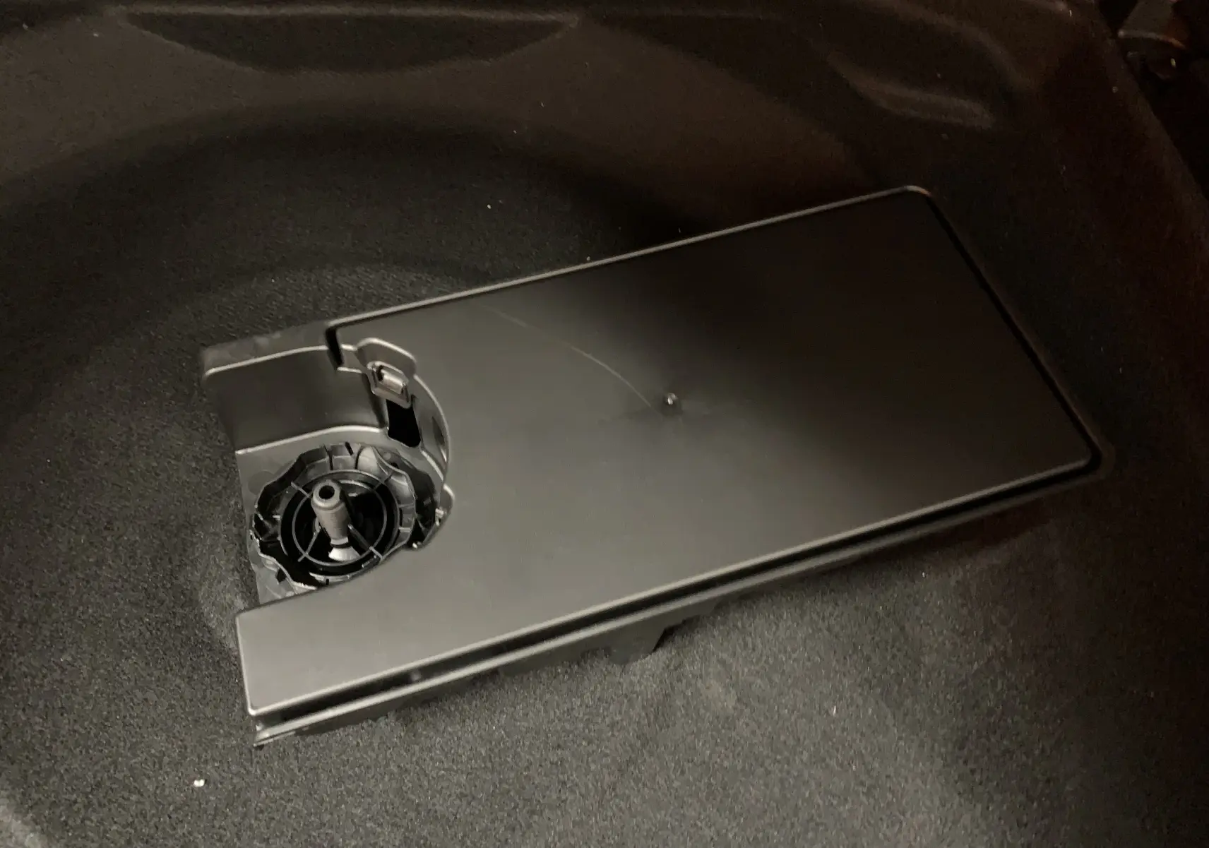 Détail du compartiment de rangement noir dans le coffre du Citroën C5 Aircross hybride blanc 2024.