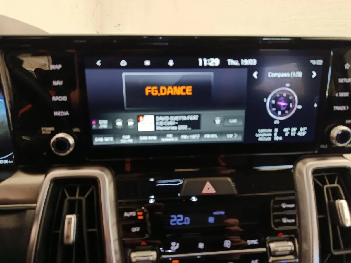 Vue rapprochée de l’écran tactile central et des commandes de climatisation du Kia Sorento noir 2023 hybride rechargeable.