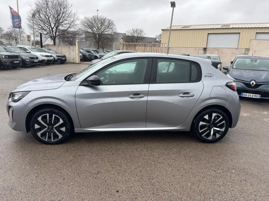 Peugeot 208 Hybrid gris vue de profil côté gauche, avec jantes 16 pouces et badge Style sur l'aile arrière.