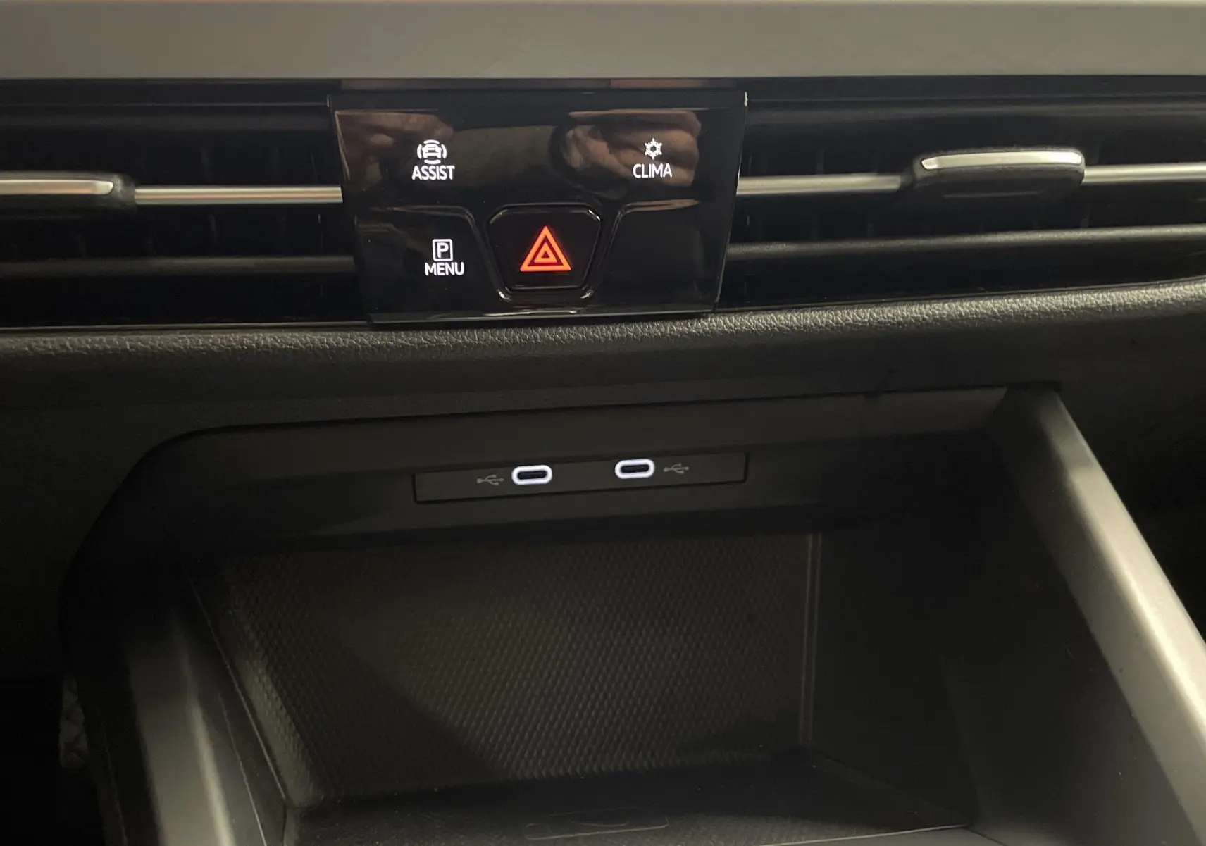 Gros plan sur la console centrale d'une Volkswagen Golf 2.0 TDI 115 DSG7 Life Business avec ports USB-C et commandes d'assistance.