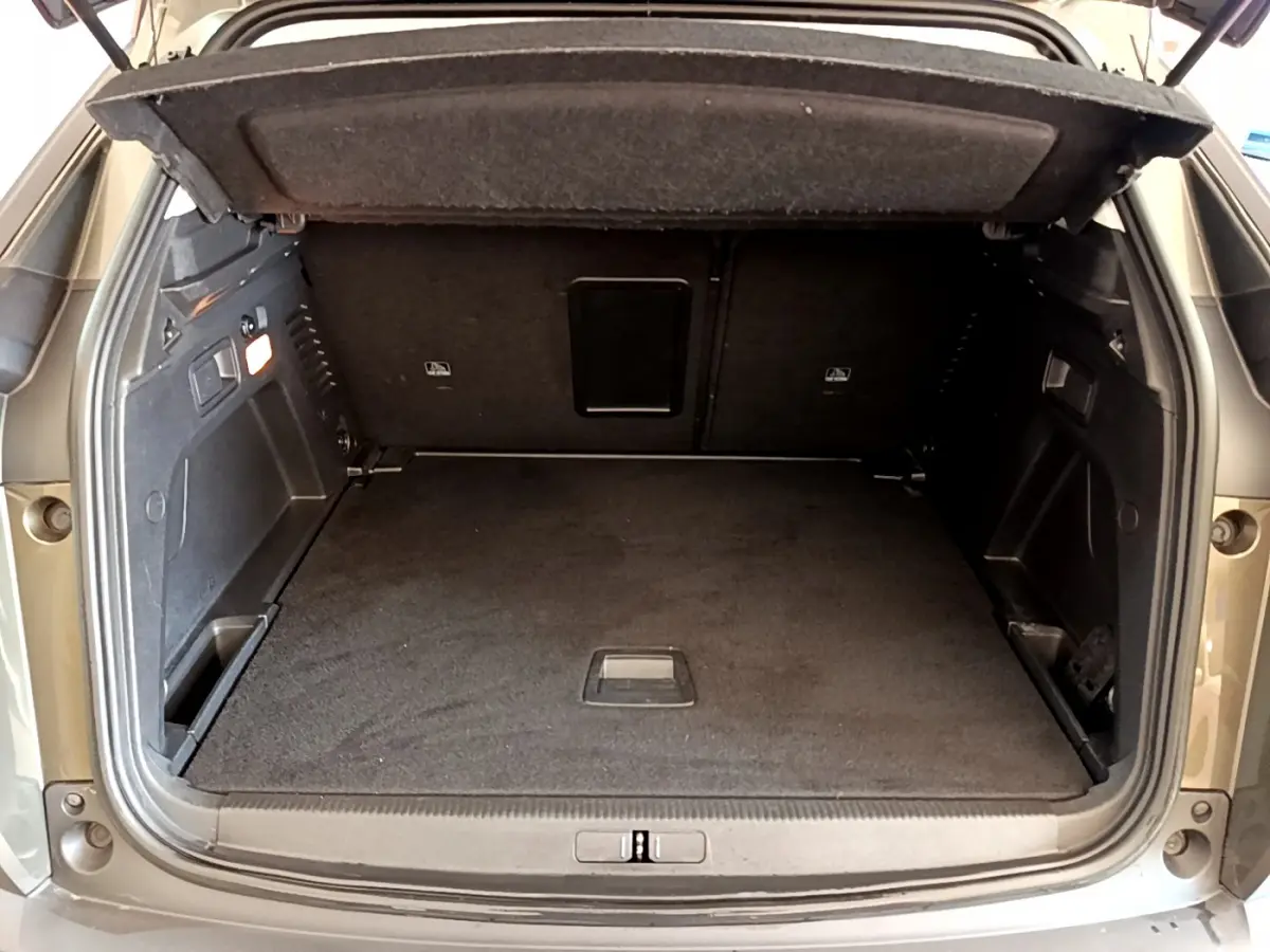 Coffre ouvert du Peugeot 3008 gris foncé, vue arrière montrant l'espace de chargement et la tablette cache-bagages.