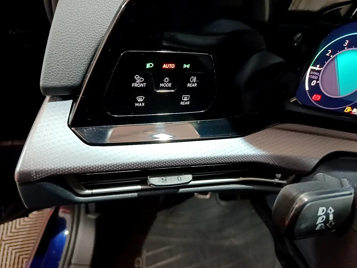 Détail du panneau de commandes d’éclairage et ventilation à gauche du tableau de bord de la Volkswagen Golf bleue 2022.