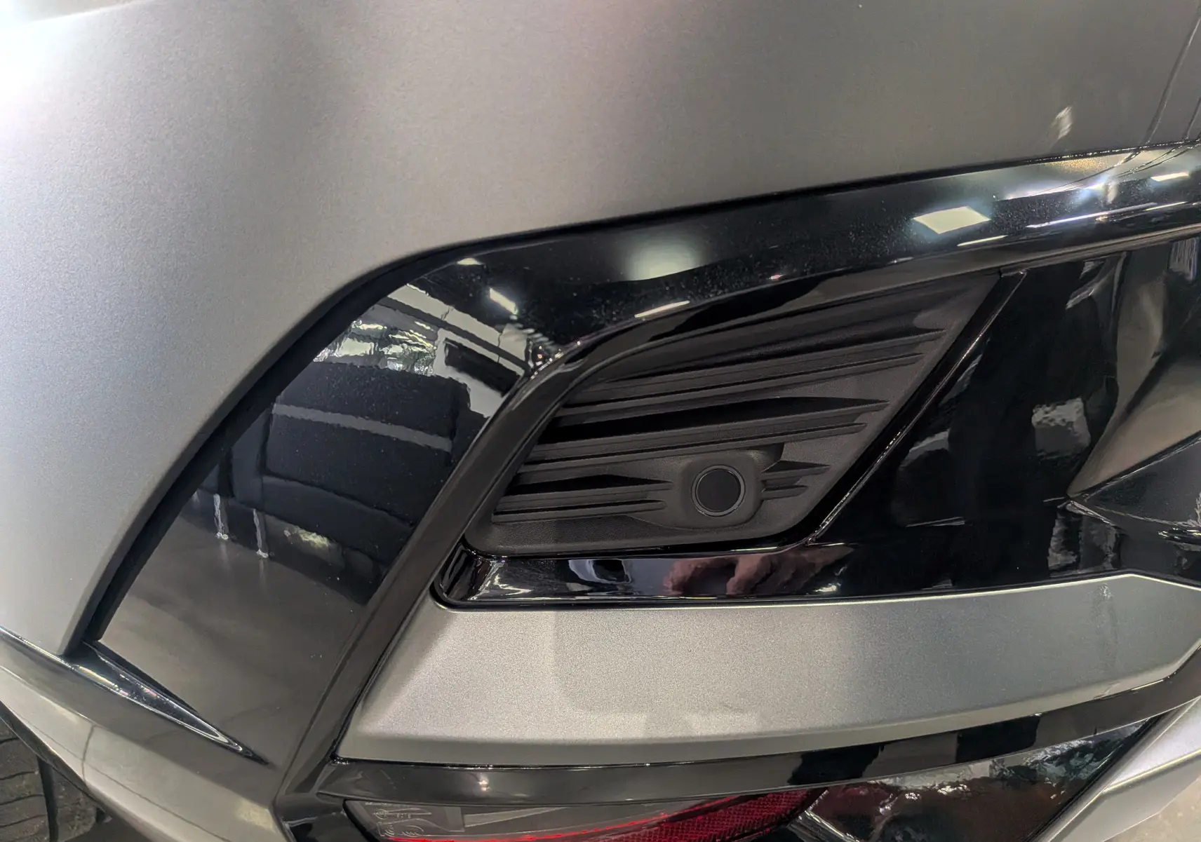 Gros plan sur le feu arrière droit du Renault Rafale gris schiste satin, soulignant les détails noirs brillants et mats.