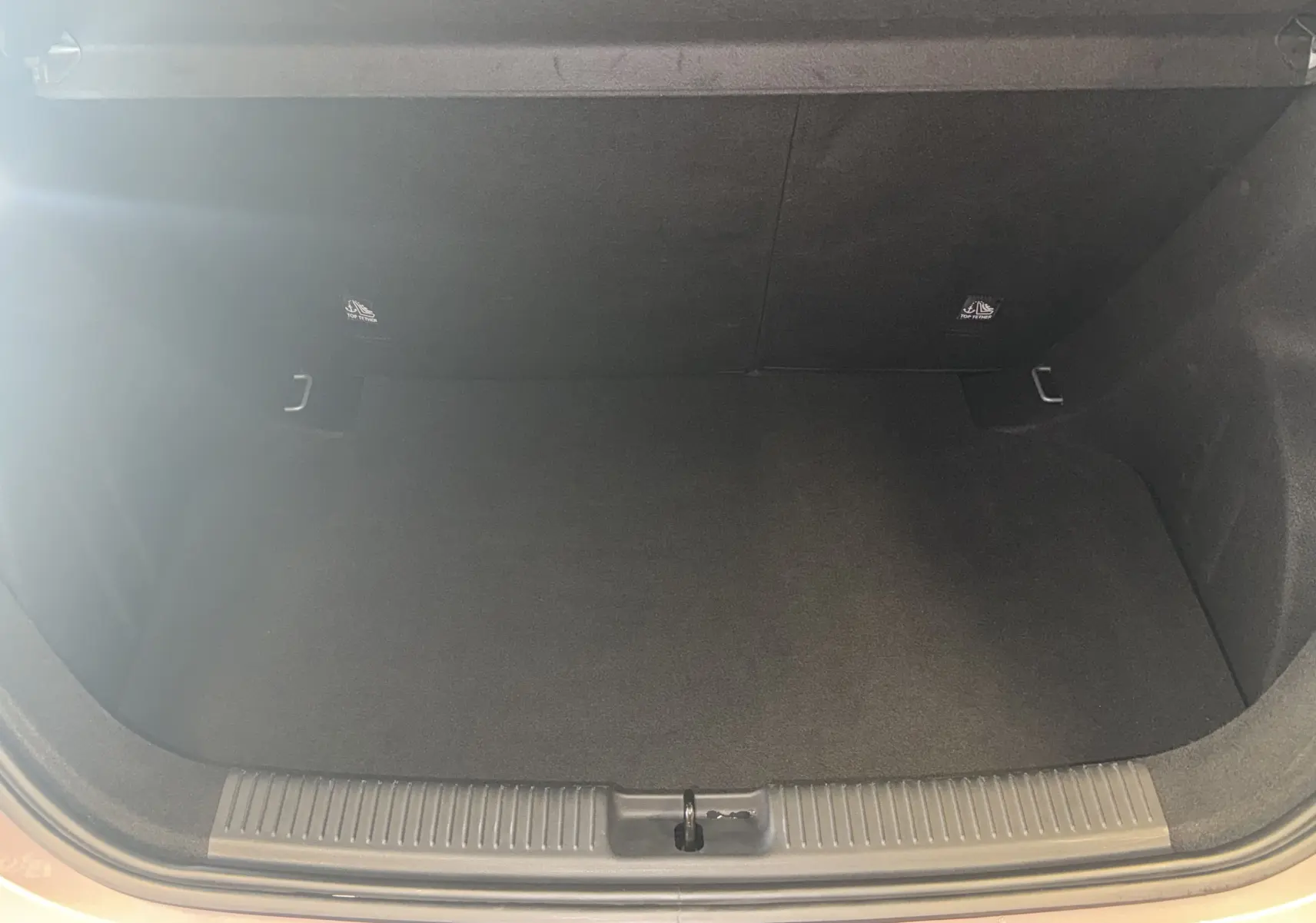 Coffre ouvert vu de face du MG3 1.5 L Hybrid+ gris Hampstead, intérieur noir et espace de rangement vide.
