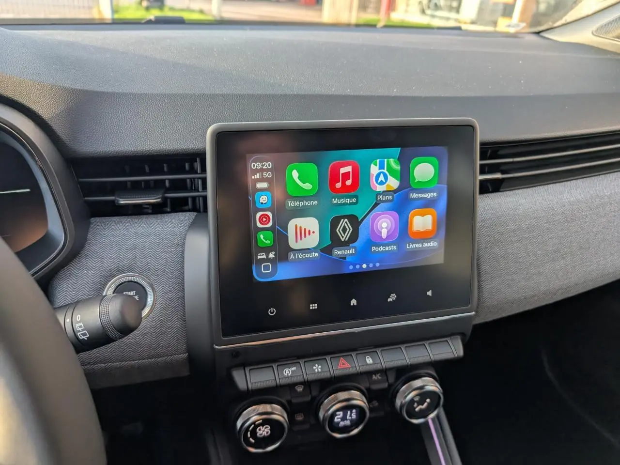 Écran tactile central avec interface multimédia Apple CarPlay dans le tableau de bord gris de la Renault Clio 2025.