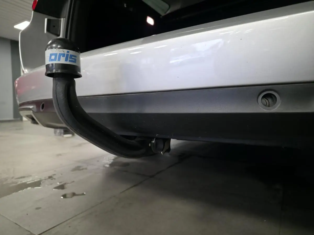 Gros plan sur l'attelage démontable noir sous le pare-chocs arrière gris platine d'une Renault Talisman Estate 2018.