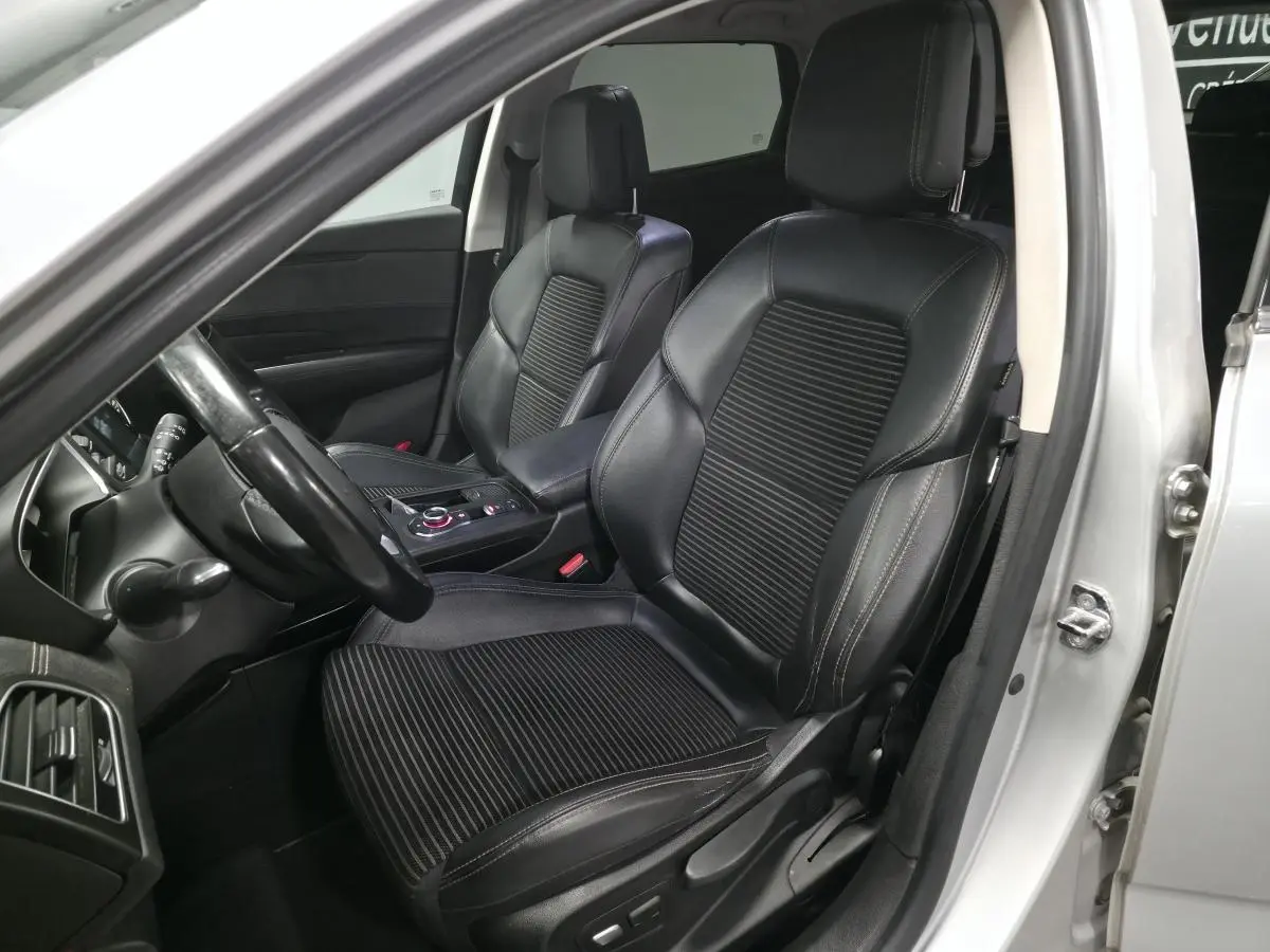 Vue intérieure côté conducteur de la Renault Talisman Estate gris, sièges cuir noir et tableau de bord partiel visible.