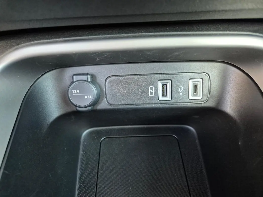 Vue rapprochée de la console centrale du Jeep Avenger noir 2024 montrant prises USB et prise 12V.