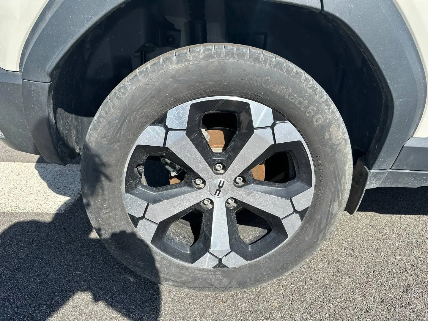Gros plan sur la roue avant droite du Dacia Duster 2025 couleur Sandstone avec jante alu au design hexagonal.