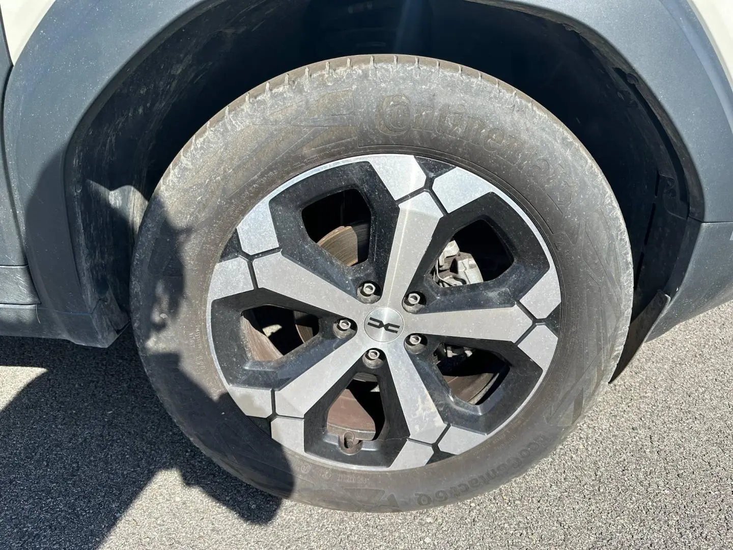 Gros plan sur la jante alu noire et grise du côté avant droit du Dacia Duster Sandstone 2025.