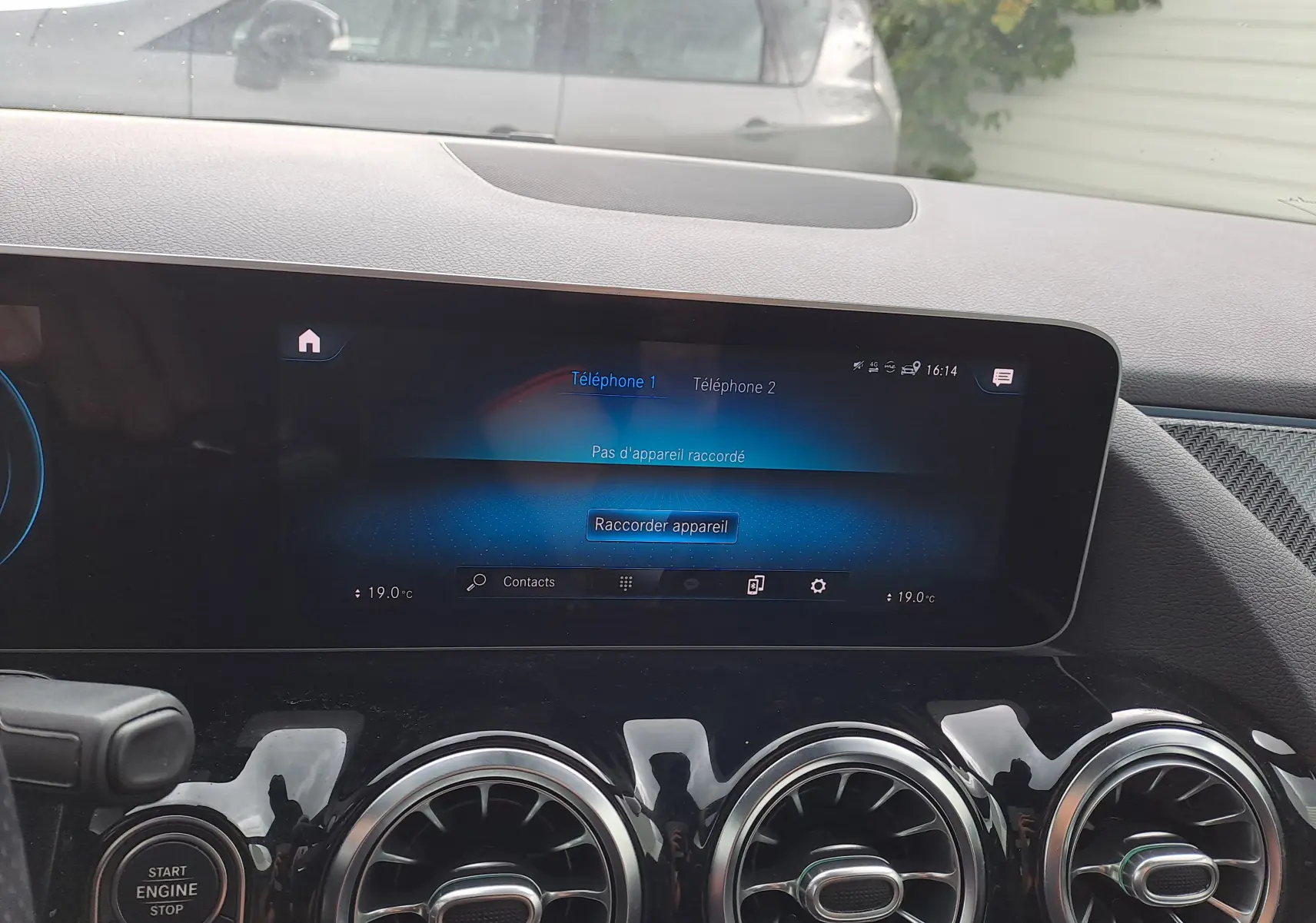 Écran tactile central et trois aérateurs ronds chromés du tableau de bord d'une Mercedes Classe B AMG Line 2019.