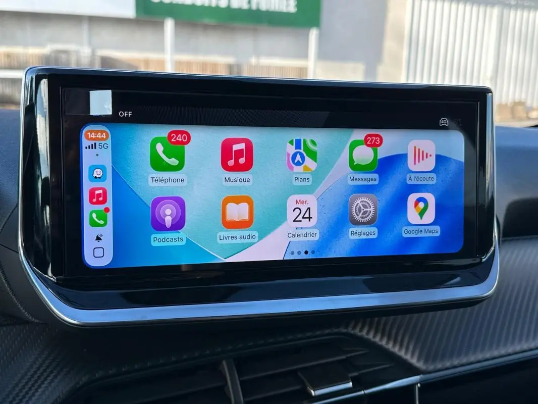 Écran tactile du tableau de bord du Peugeot 208 Hybrid blanc, affichant des applications connectées.