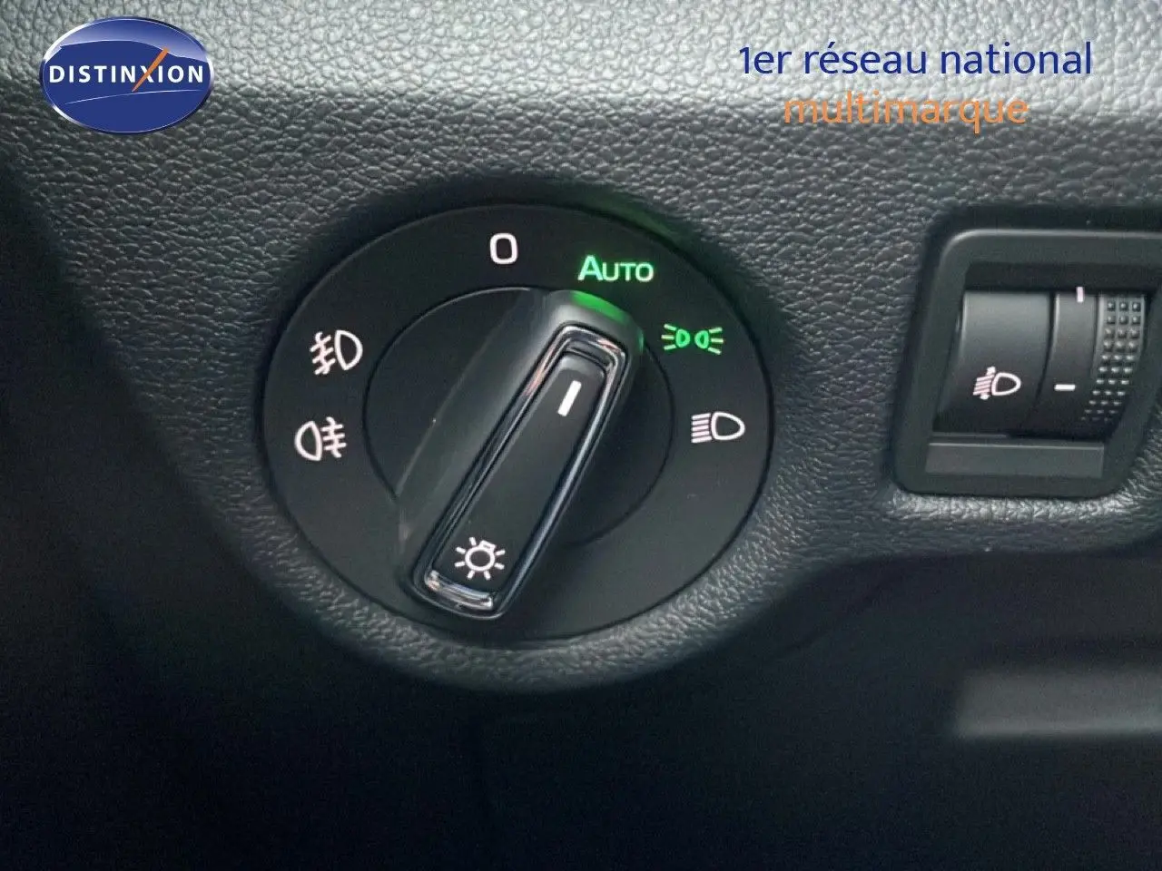 Gros plan sur la commande des phares du Skoda Kamiq 2025 en gris graphite, avec réglage automatique activé.