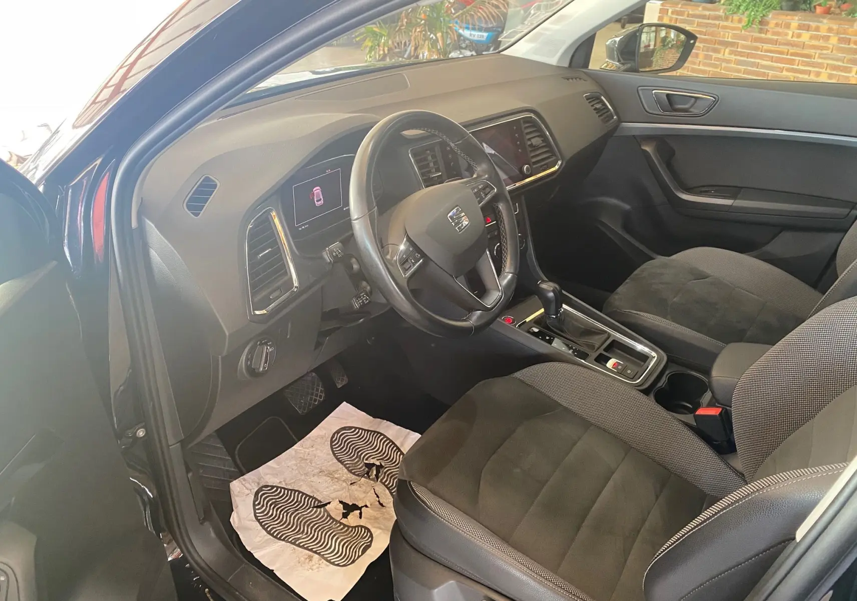 Intérieur noir du SEAT Ateca 2019 vu côté conducteur, avec volant multifonction et console centrale équipée.