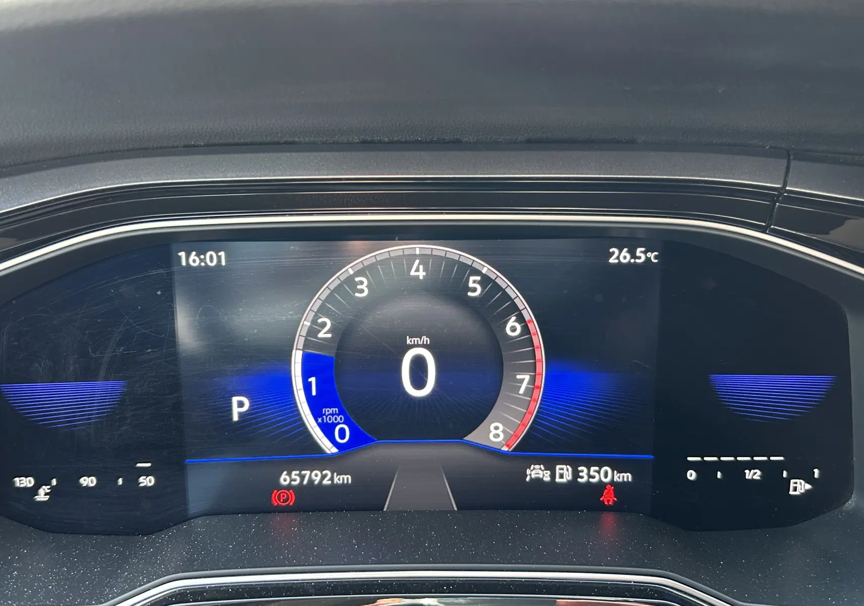 Tableau de bord numérique du Volkswagen Taigo blanc, affichant vitesse à 0 km/h et température extérieure à 26,5°C.