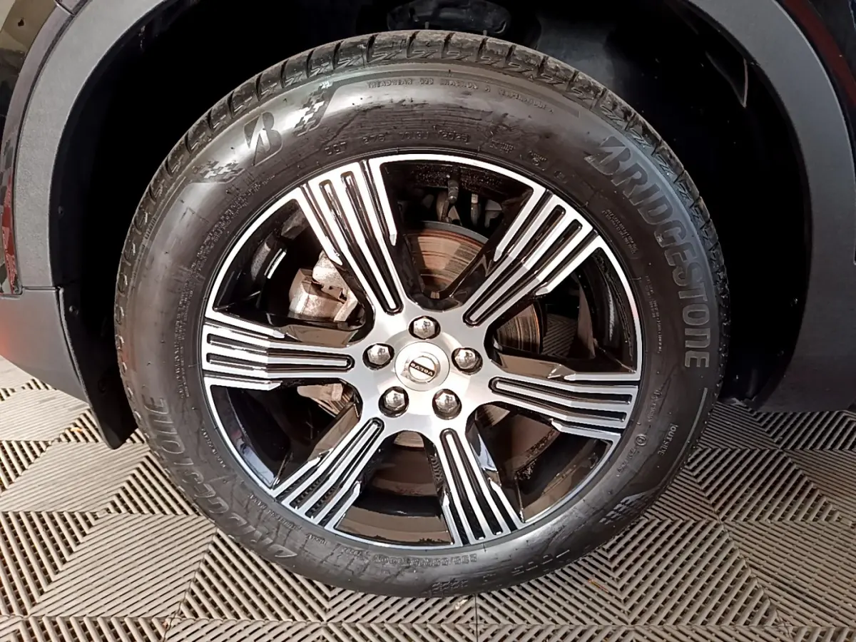 Gros plan sur la jante alliage noir et argentée d'un Volvo XC40 T3 2020, avec pneu Bridgestone visible.