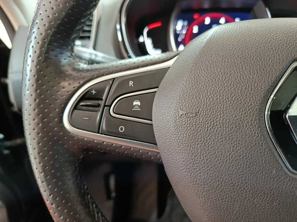 Gros plan sur le volant cuir perforé avec commandes multifonctions du Renault Espace Initiale Paris noir 2018.