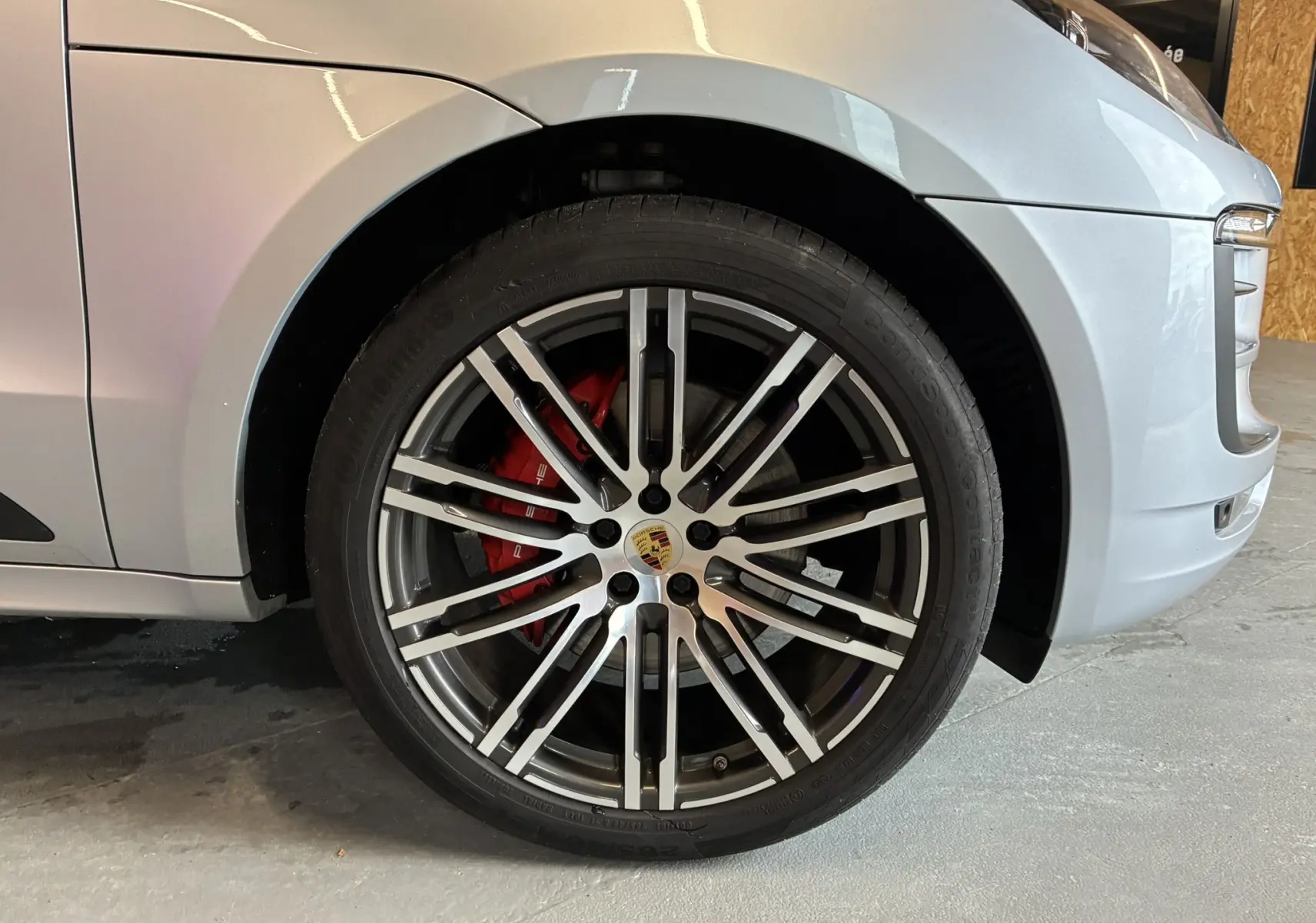 Gros plan sur la roue avant droite argentée d'un Porsche Macan GTS 2017 avec étrier de frein rouge visible.