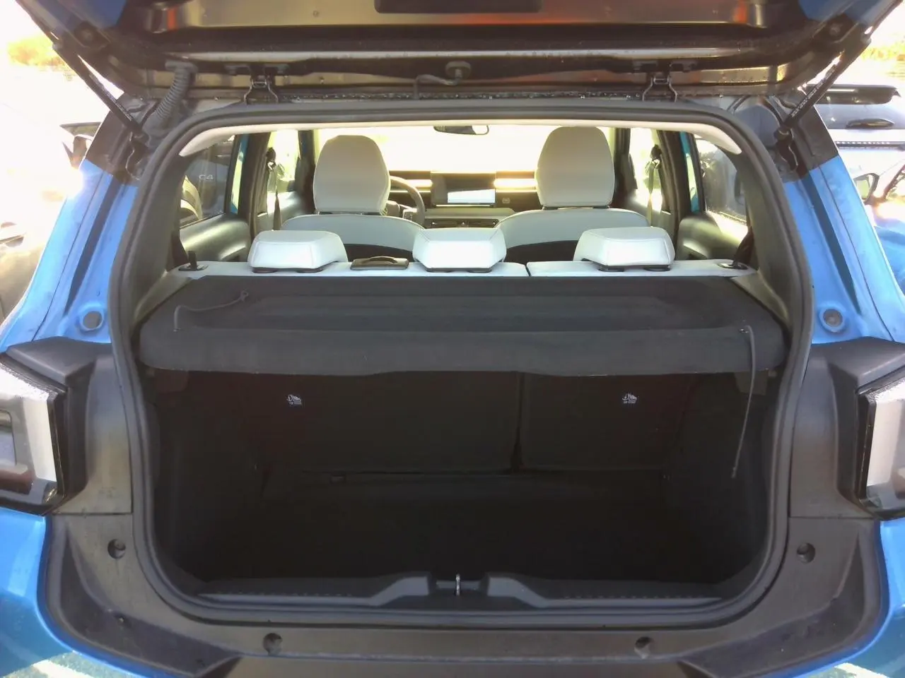 Coffre ouvert vu de l'arrière d'une Citroën C3 2025 Bright Blue avec intérieur clair et hayon relevé.