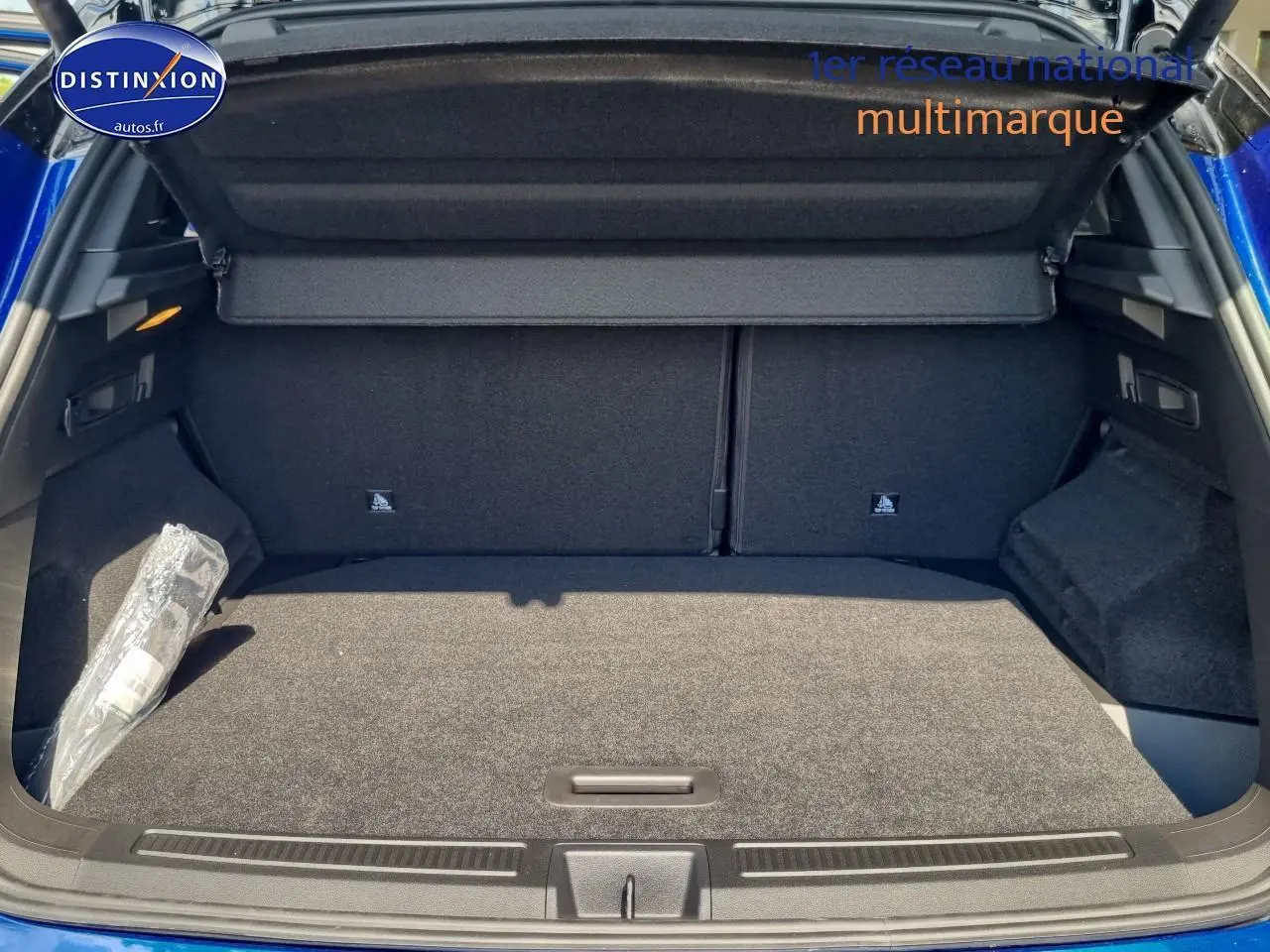 Coffre ouvert du Renault Austral bleu iron, montrant un espace de chargement propre et bien agencé avec cache-bagages.