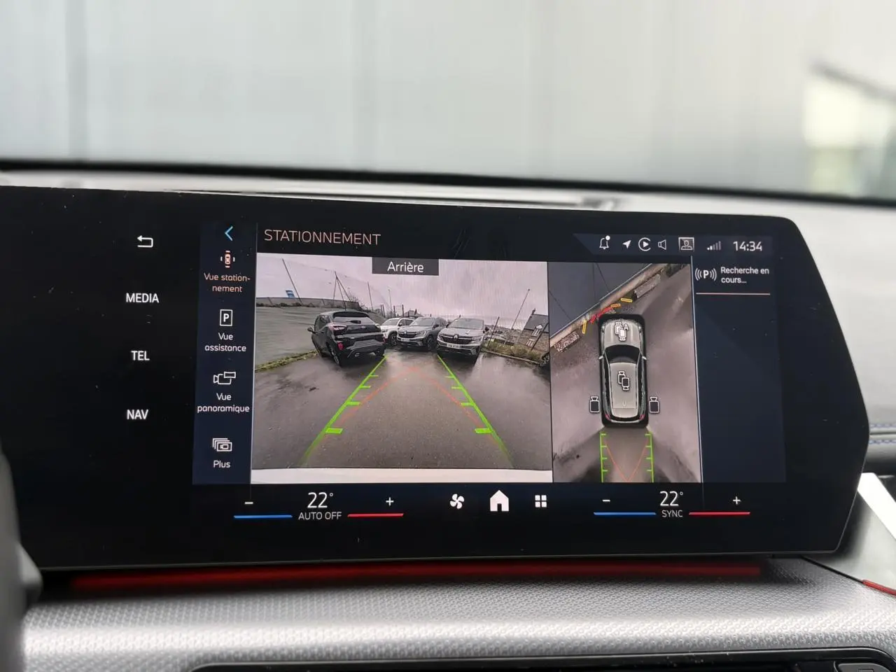 Affichage écran intérieur du BMW X1 blanc Mineral montrant la caméra de recul et vue 360° en stationnement.