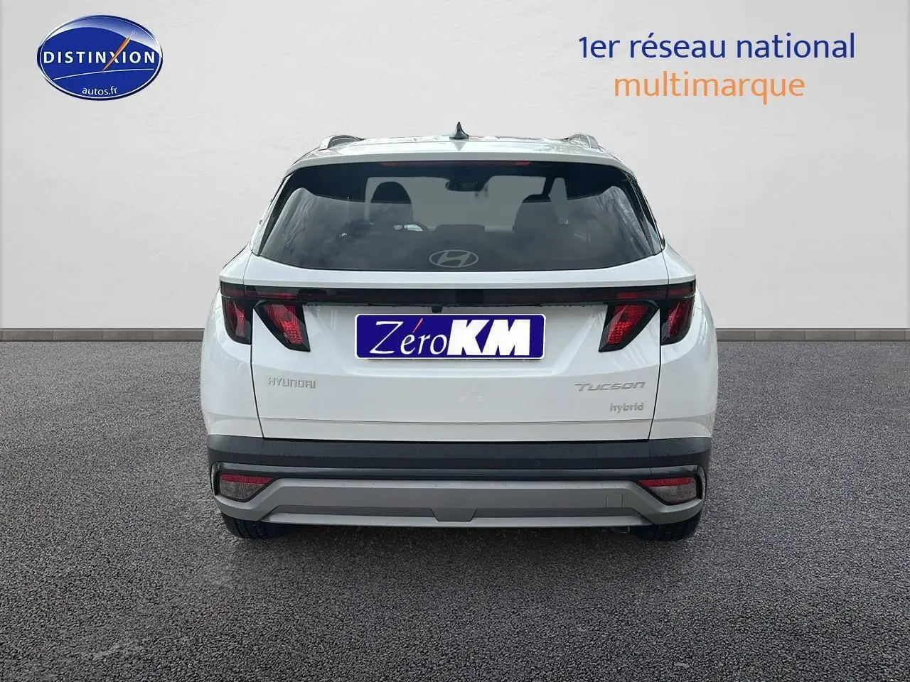 Vue arrière d'un Hyundai Tucson blanc Sérénité 2025 avec feux arrière LED et logo Hyundai visible.