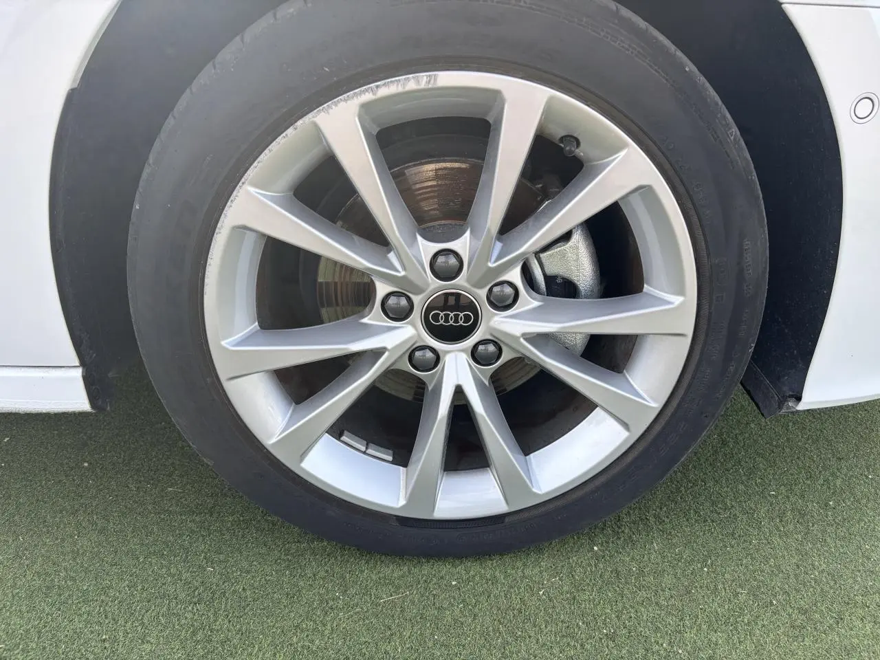 Gros plan sur la jante alliage 5 branches parallèles de l'Audi A3 Blanc Arkona côté avant droit.