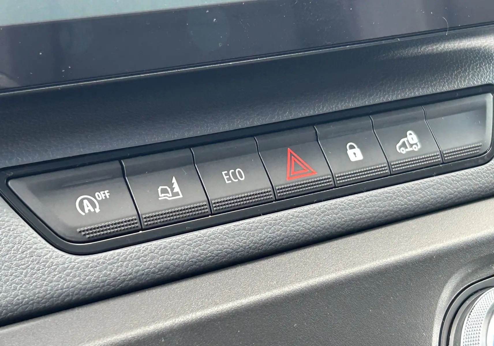 Gros plan sur la rangée de boutons de commande du tableau de bord du Renault Master IV blanc, avec bouton ECO et alerte de danger.
