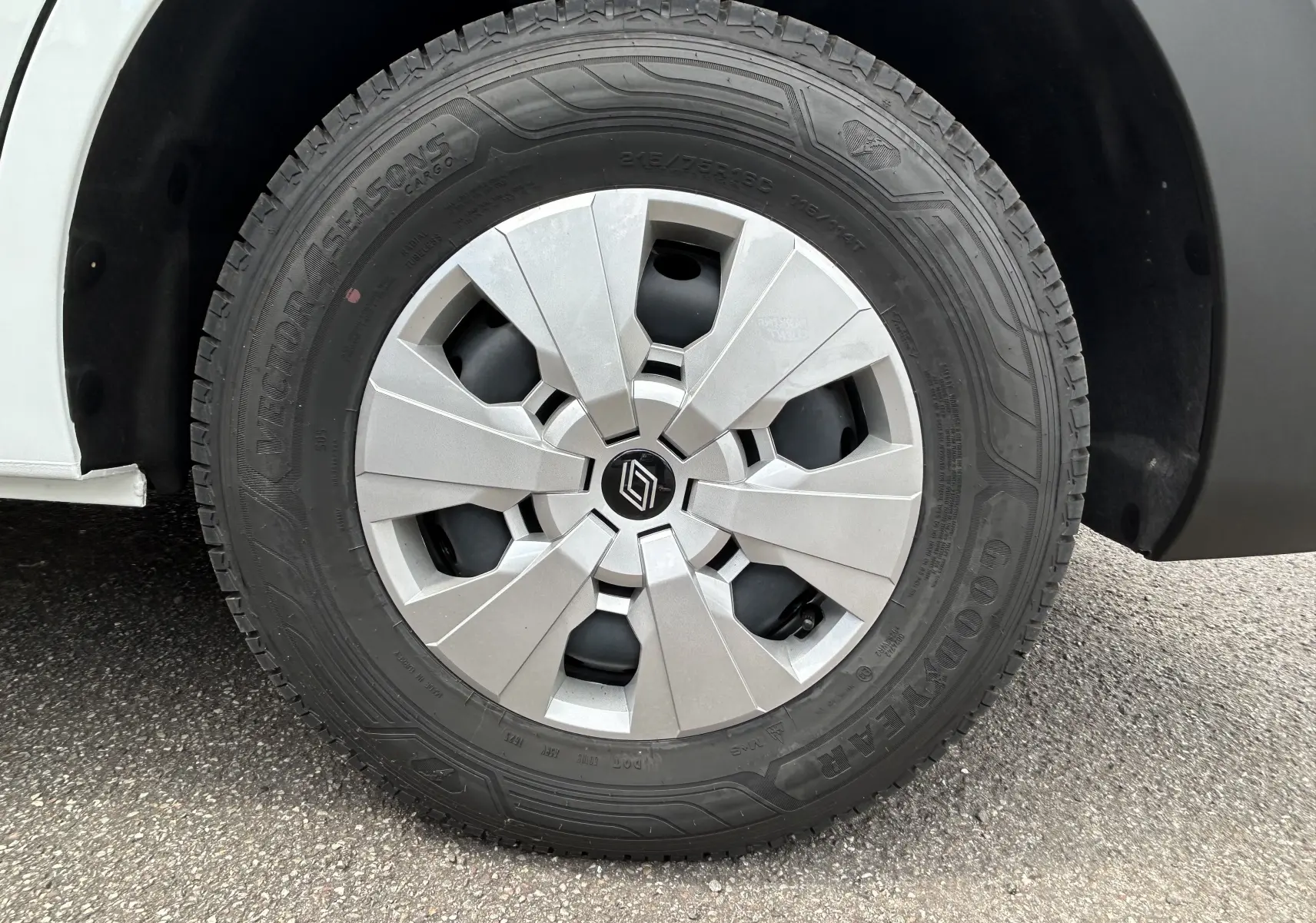 Gros plan sur la roue avant droite d’un Renault Master blanc avec jante argentée et pneu Goodyear.