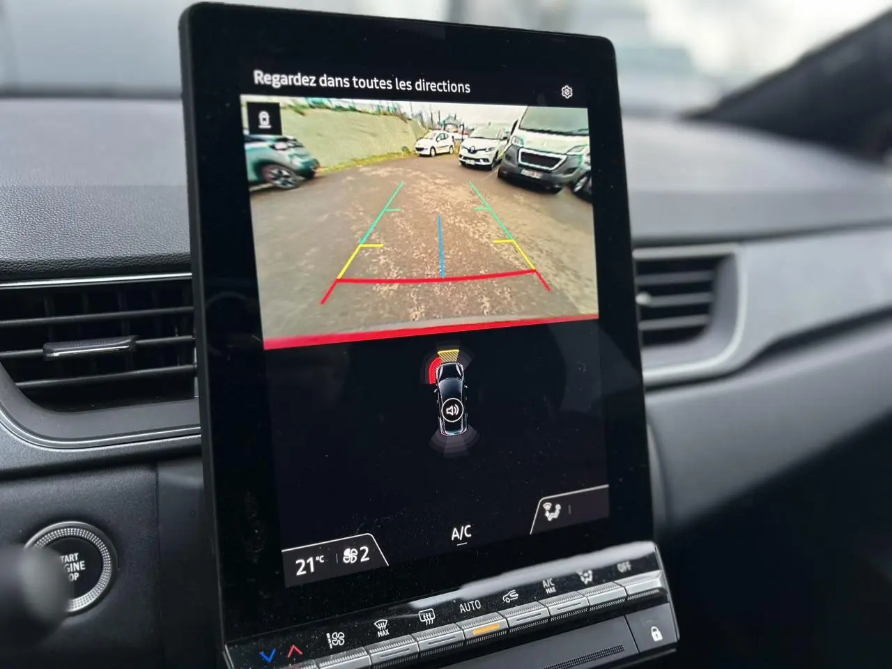 Écran tactile central du Renault Captur 2025 affichant la caméra de recul et l’aide au stationnement, intérieur noir.