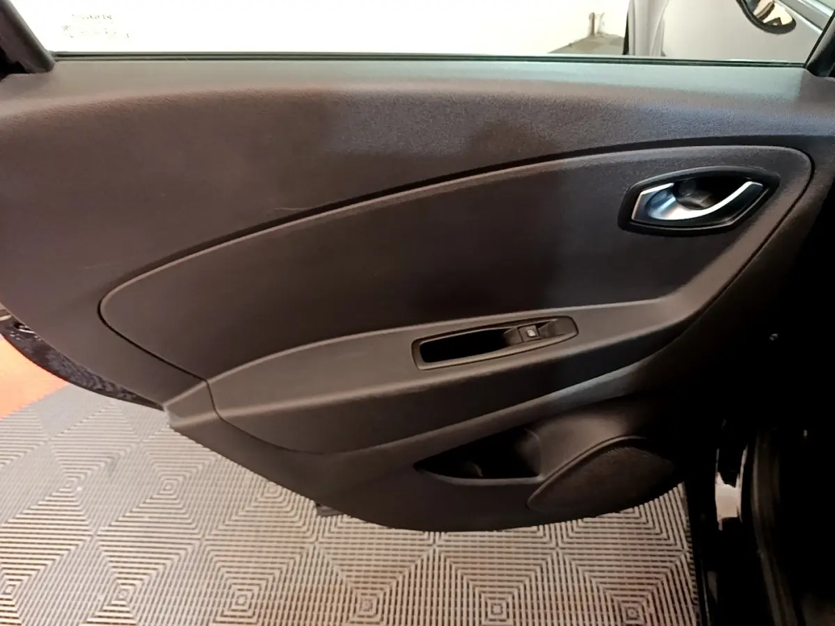 Vue rapprochée de la porte intérieure côté conducteur noire du Renault Captur Business TCe 90 de 2018, avec poignée et commande de fenêtre.