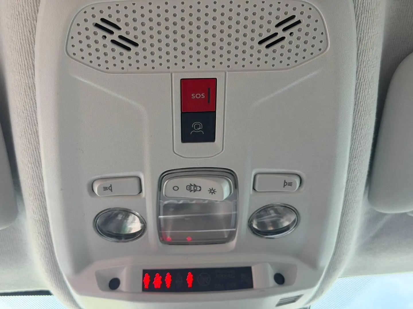 Vue rapprochée du plafonnier intérieur blanc avec boutons d’éclairage et alerte SOS dans une Peugeot 208 1.2 Hybrid 2025.