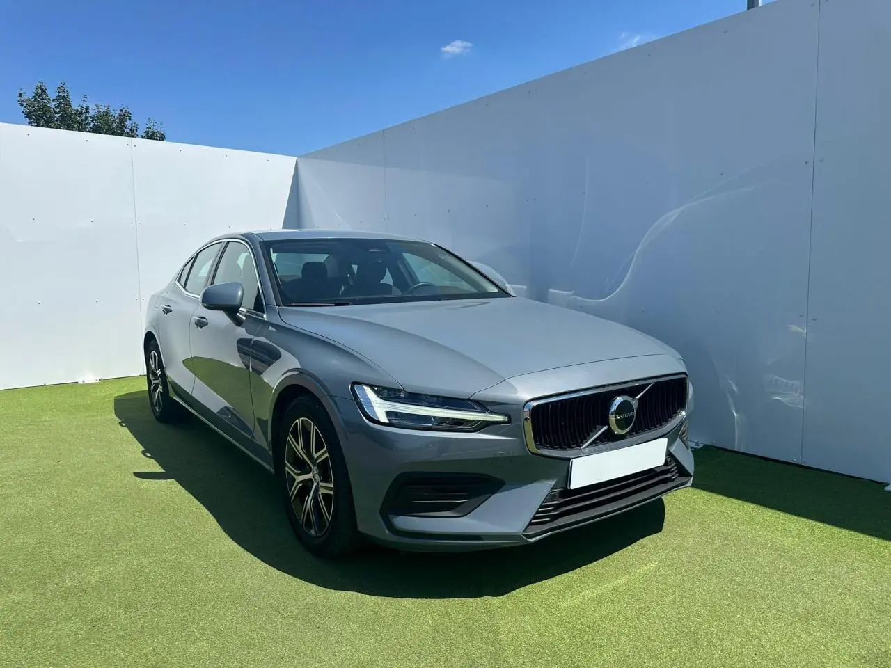 Volvo S60 2024 gris Thunder Grey vue 3/4 avant avec calandre chromée et phares LED design marteau de Thor