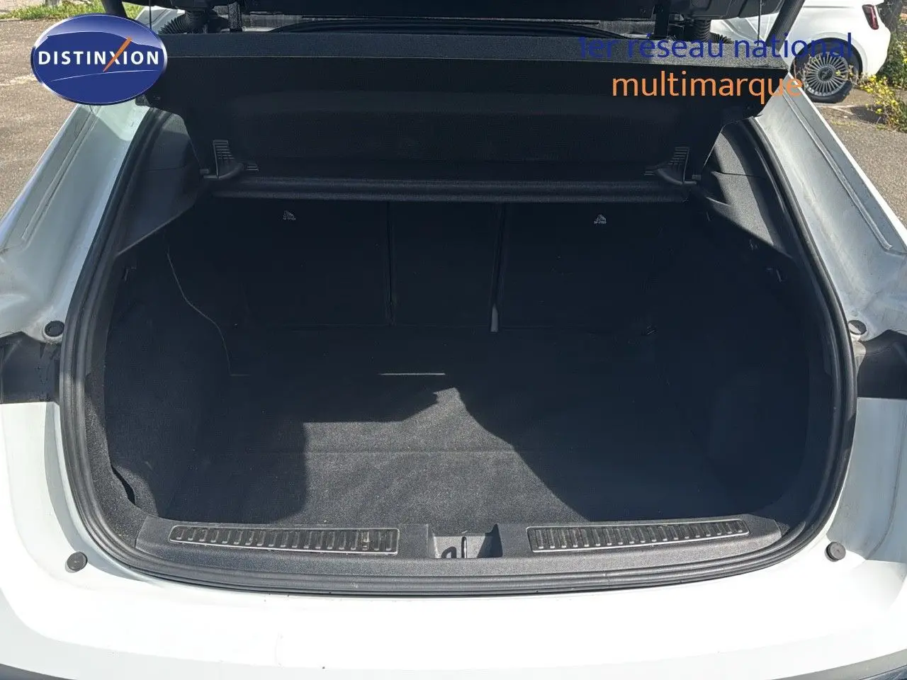 Coffre ouvert vue arrière d'une Renault Rafale 2024 blanc satin avec toit noir, version hybride esprit Alpine.