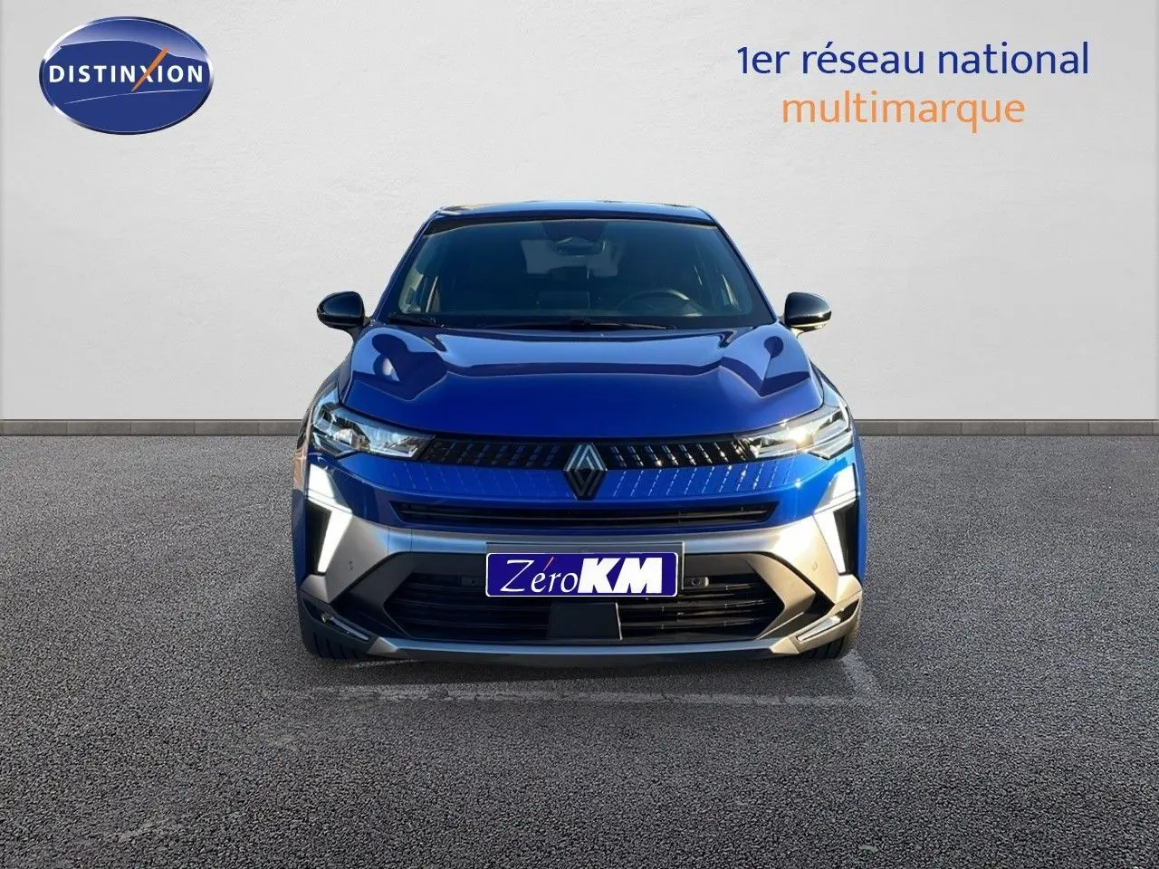 Vue frontale d'un Renault Captur E-Tech hybride bleu Iron Metal avec calandre noire et éclairage LED distinctif.