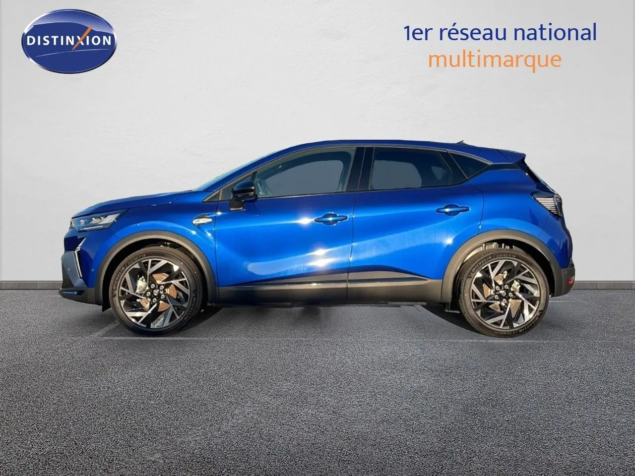 Profil côté gauche du Renault Captur E-Tech hybride 2025 en bleu Iron Metal avec jantes alliage bicolores.