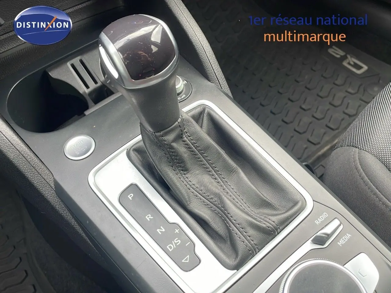 Le levier de vitesse automatique en cuir noir de l'Audi Q2 35 TFSI S-Line vu de près dans l'habitacle.