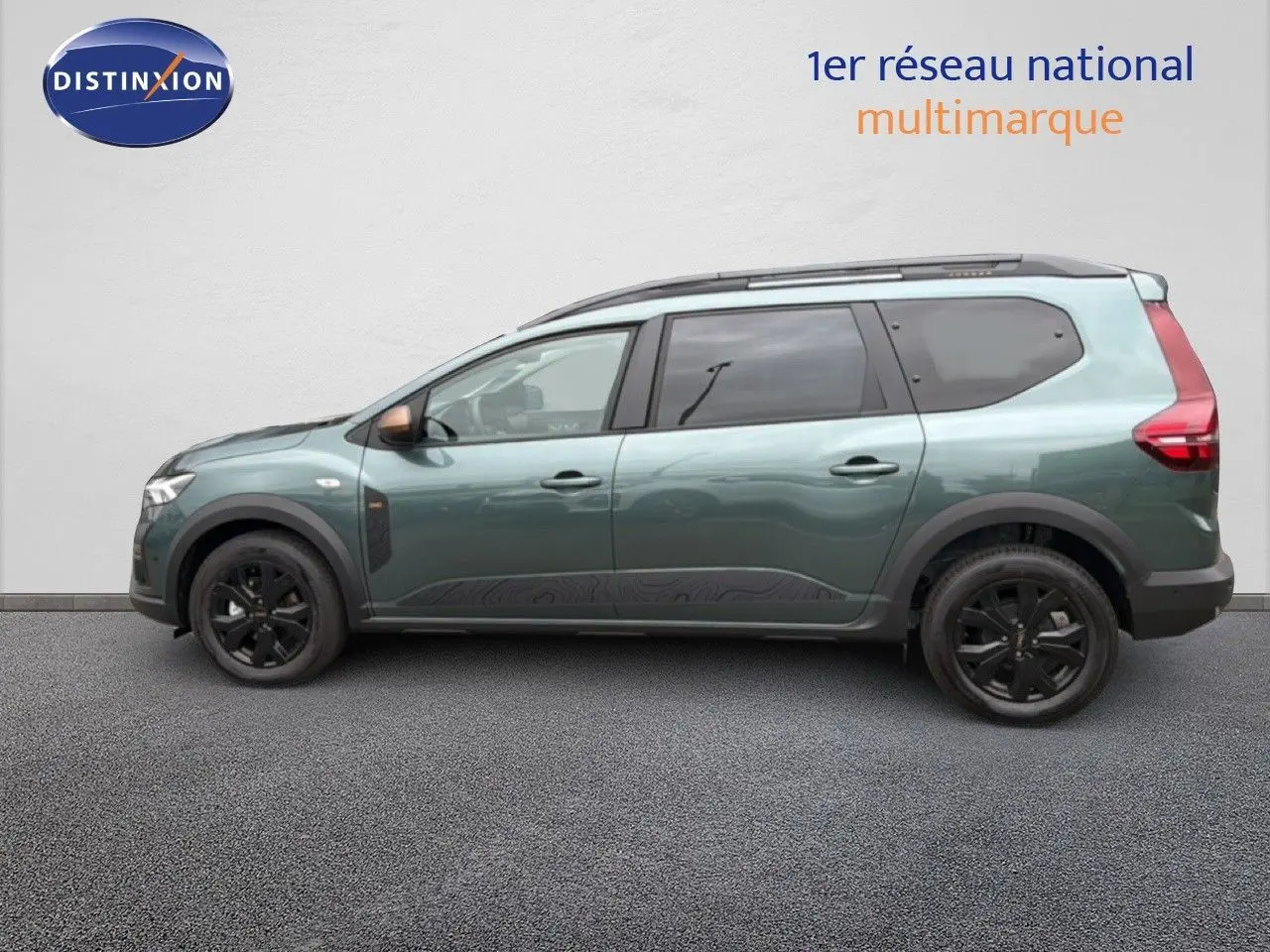 Vue latérale gauche d'un Dacia Jogger 2026 vert cèdre métallisé avec jantes noires et protections de bas de caisse.