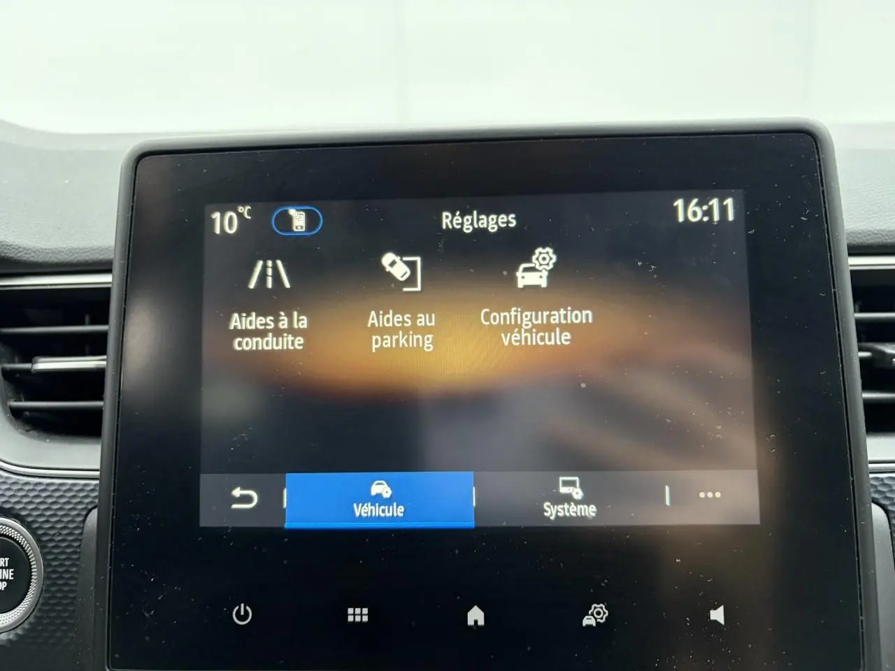 Écran tactile central de la Renault Arkana bleu Zanzibar affichant les réglages d’aides à la conduite.
