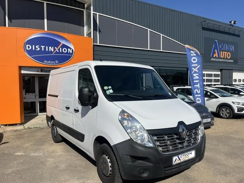 Renault Master blanc Glacier en 3/4 avant droit, devant un concessionnaire avec drapeau Distinxion visible.