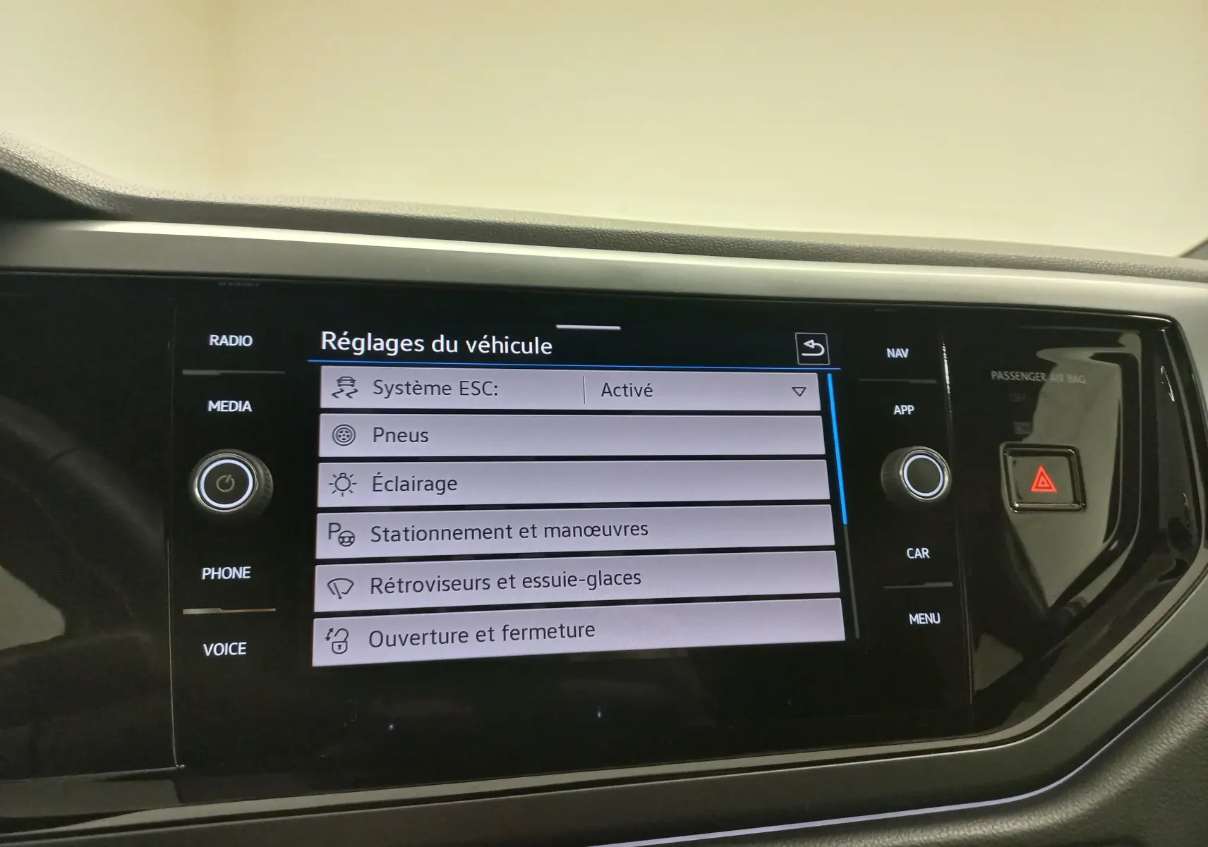 Écran tactile central du tableau de bord de la Volkswagen Polo blanc pur affichant les réglages du véhicule.