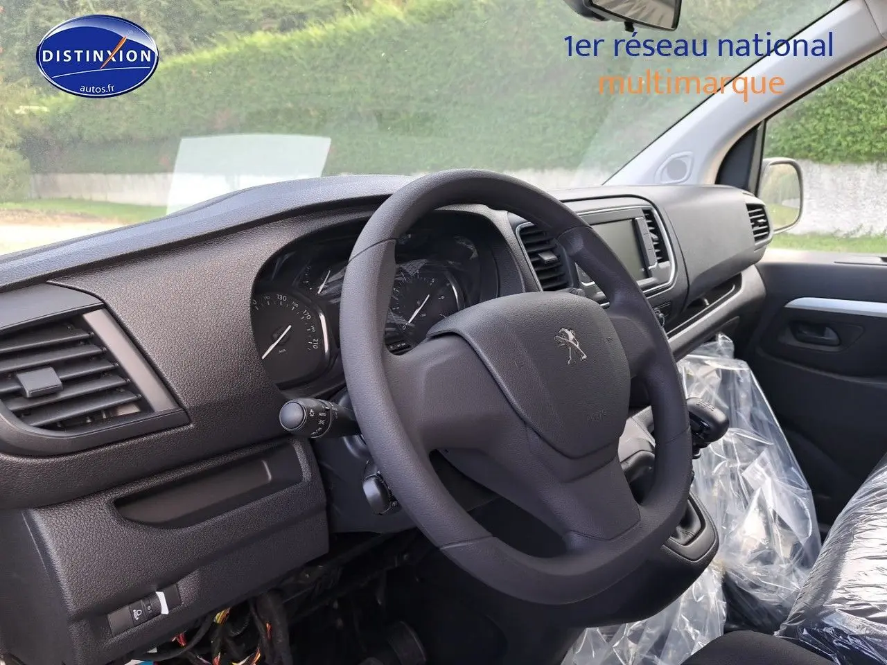 Intérieur du Peugeot Expert Cabine Approfondie 2023, vue côté conducteur sur volant et tableau de bord noir.