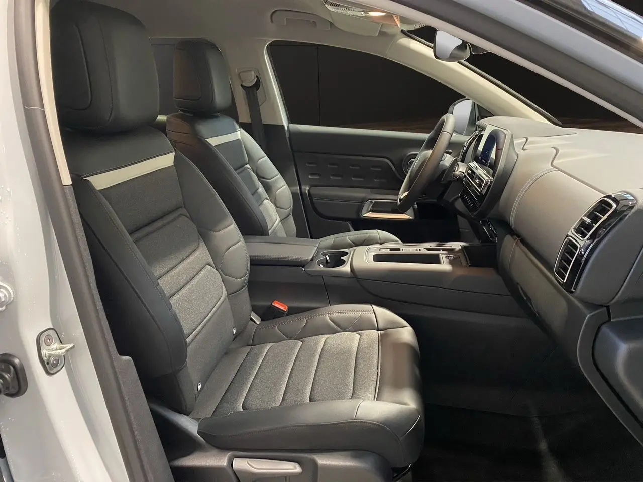 Intérieur noir du Citroën C5 Aircross 2024, vue côté gauche sur les sièges avant et le tableau de bord moderne.