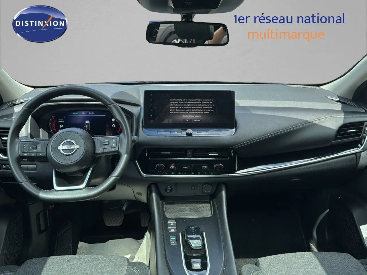 Vue frontale de l'intérieur du Nissan Qashqai 2024 noir, avec tableau de bord numérique et écran tactile central.