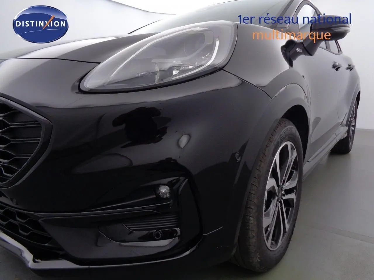 Vue 3/4 avant droit d'un Ford Puma noir Agate mettant en valeur ses optiques LED et ses jantes alliage.